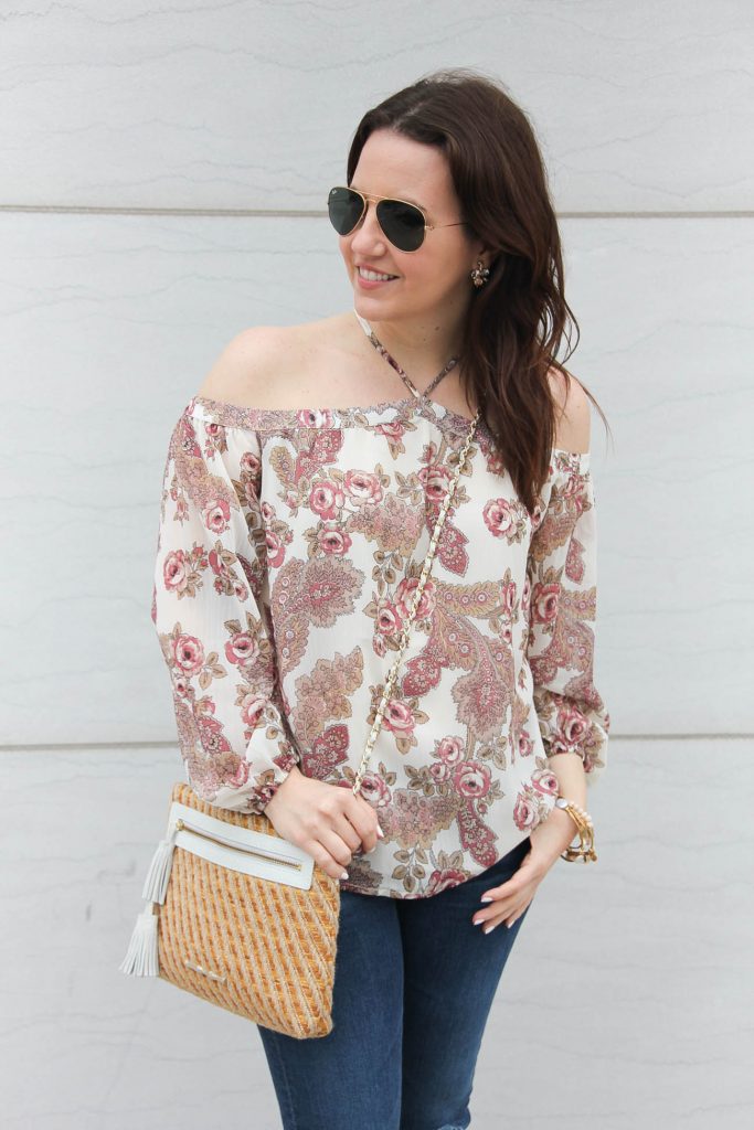 Houston fashion blogger wears a pink floral cold shoulder top with an Elaine Turner purse.