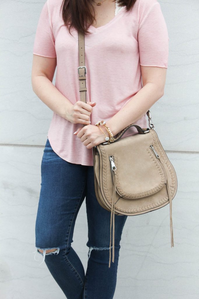 Lady in Violet, a Houston Fashion blog shares a casual weekend outfit including a pink tshirt with distressed jeans and a saddle crossbody bag.