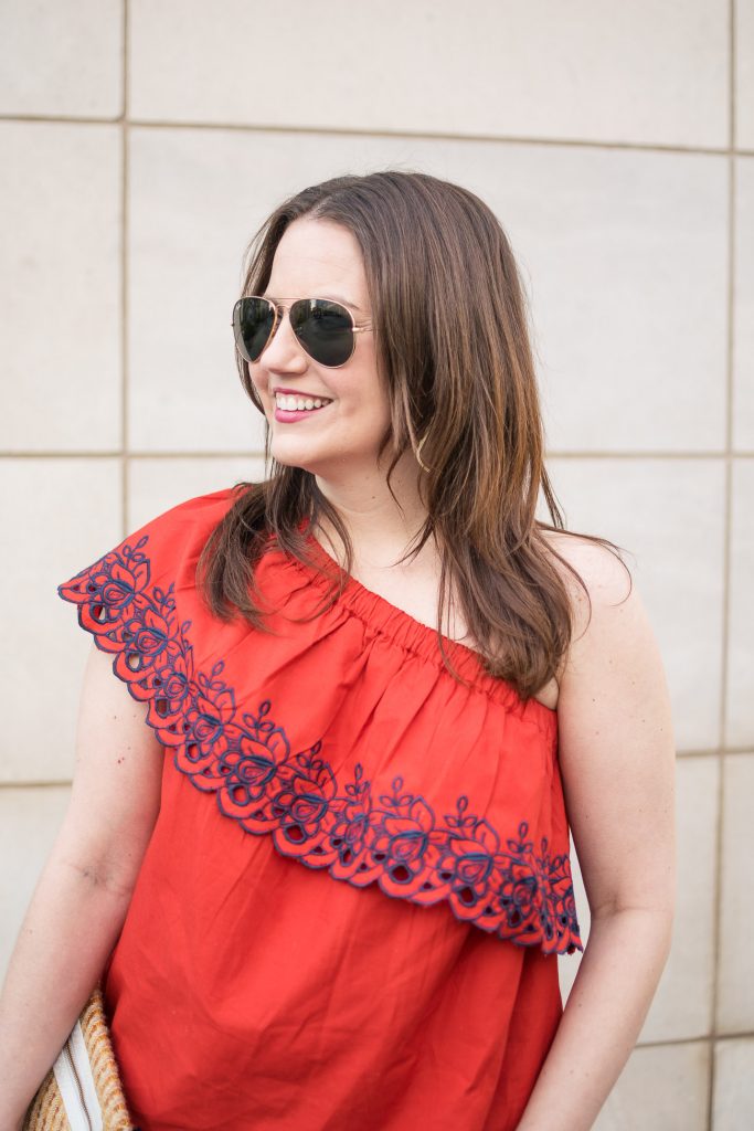 Karen Rock, a Houston fashion blogger, wears a red one shoulder top for spring outfit inspiration.