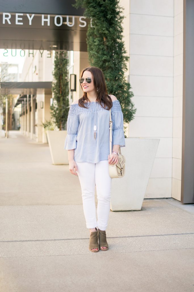 Houston fashion blogger wears a casual weekend outfit idea including white jeans, a blue off the shoudler top with brown ankle boots.