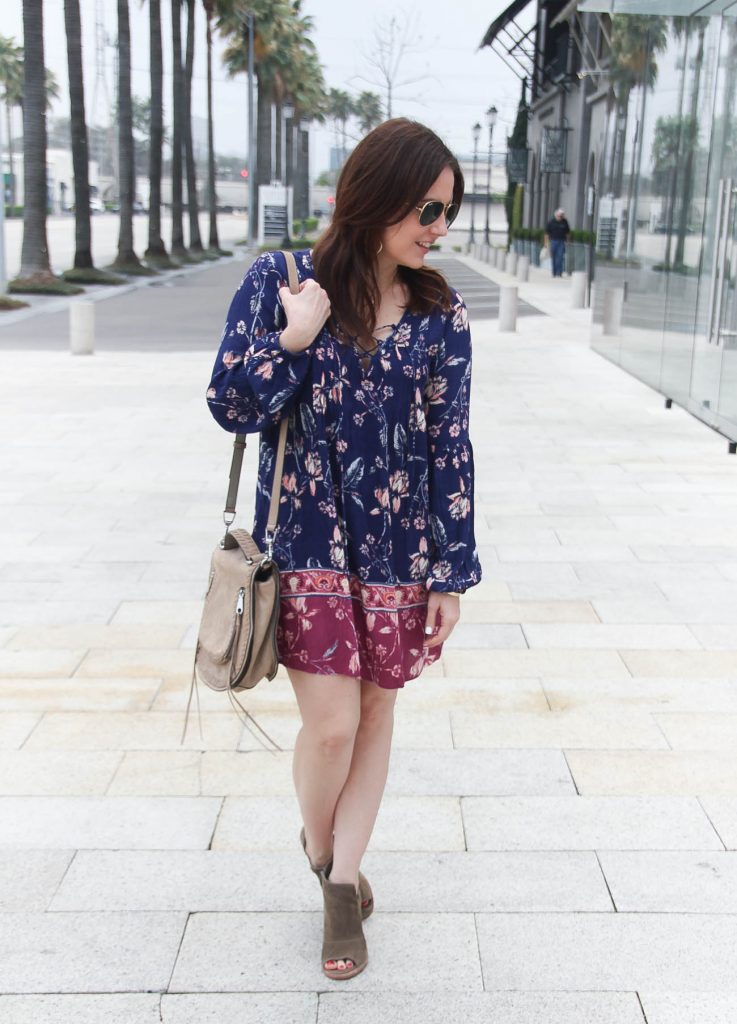 Houston fashion blogger styles a festival outfit idea including a boho floral swing dress with brown peep toe booties.