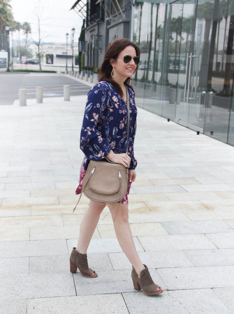 Houston fashion blogger styles boho chic outfit including a floral swing dress and booties.