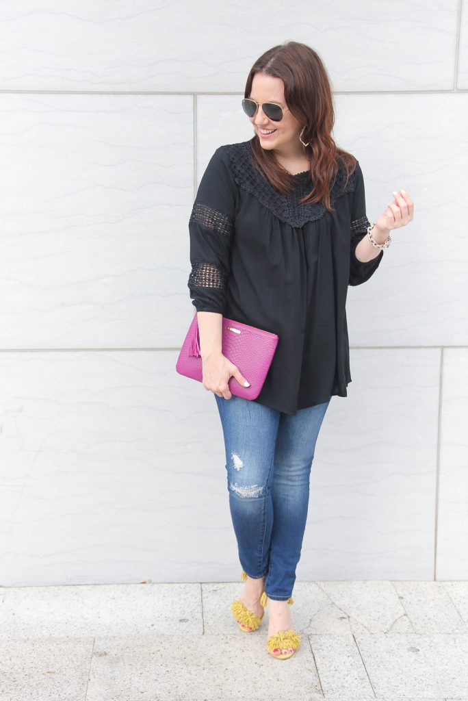 Houston fashion blogger wears spring outfit including black crochet top with yellow fringe heels.