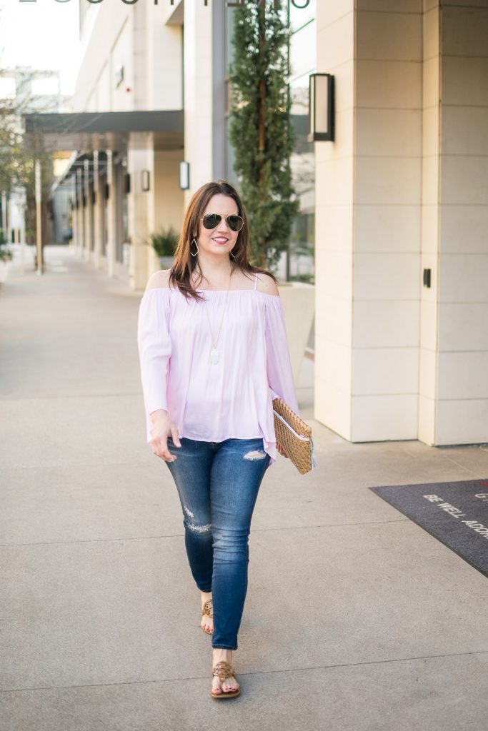 Casual weekend outfit ideas featuring distressed jeans and a pink cold shoulder top.