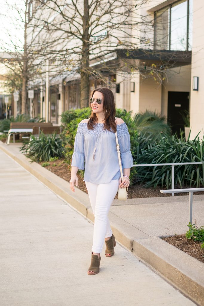 Fashion Blogger Karen Rock wears blue off the shoulder top with white jeans and booties for a weekend outfit idea.