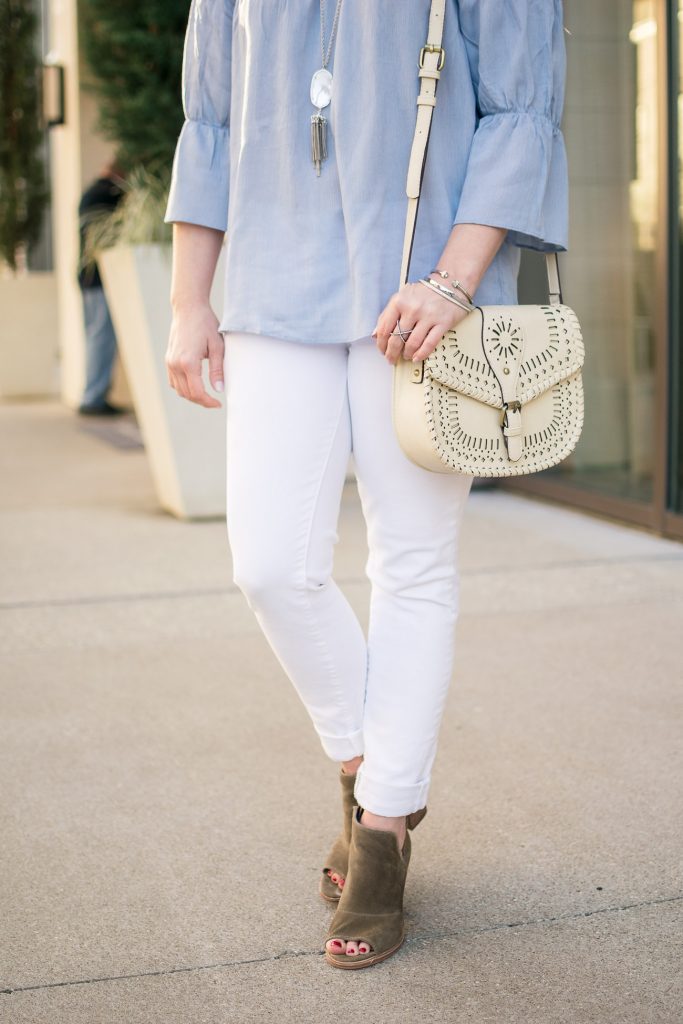 Houston blogger wears a spring outfit idea including a blue bell sleeve top with white skinny jeans and brown peep toe booties.