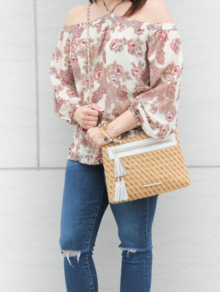 Lady in Violet shares spring outfit inspiration featuring a floral off the shoulder top with distress jeans and a spring must have bag.