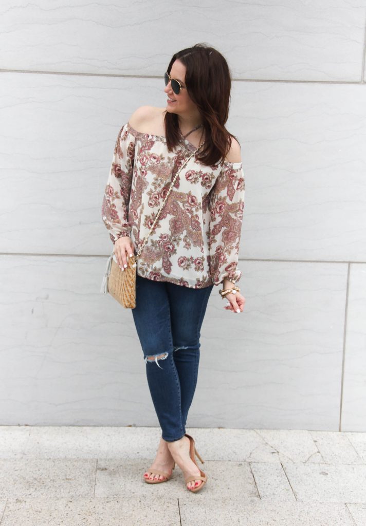 Lady in Violet, a Houston based style blogger wears a spring casual outfit idea including distressed jeans, a pink floral top, and nude sandals.