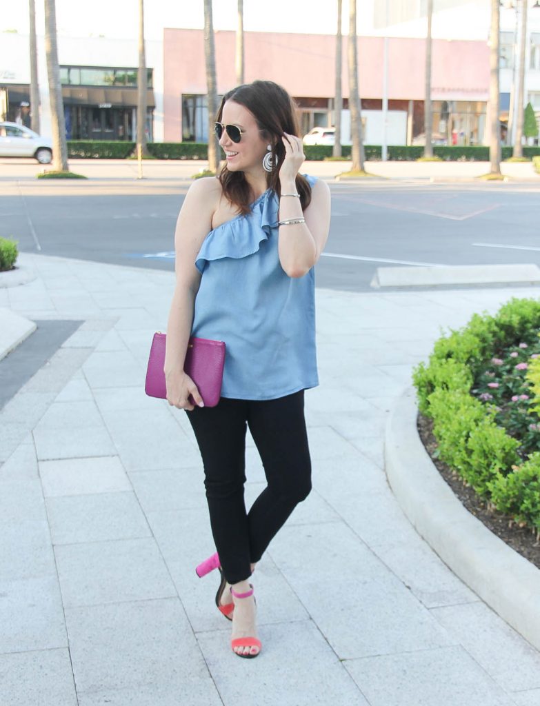 Houston fashion blogger styles spring outfit idea featuring chambray one shoulder top with black skinny jeans and block heel sandals.