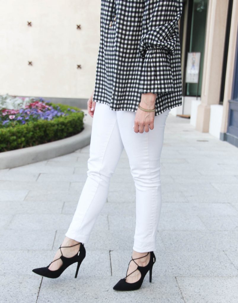 Karen Rock, a Houston fashion blogger, styles spring trends including white skinny jeans with a gingham bell sleeve top.