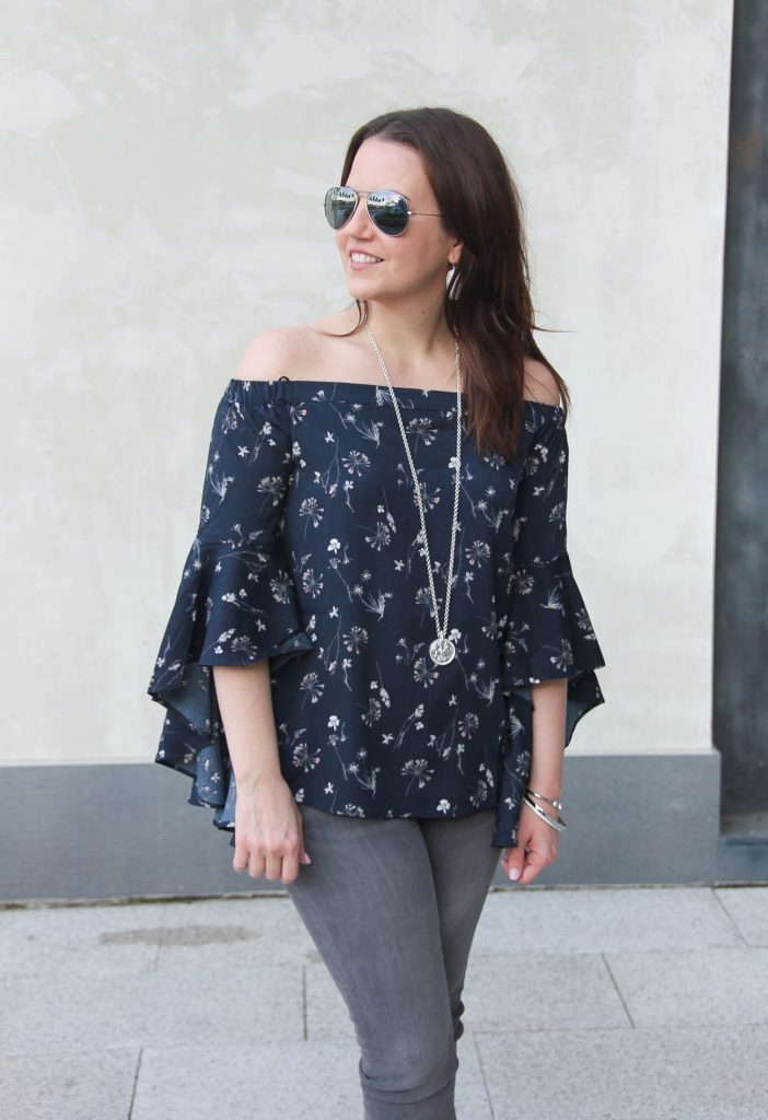 Lady in Violet, a Houston based fashion blogger wears a Nordstrom floral bell sleeve off the shoulder top with gray jeans.