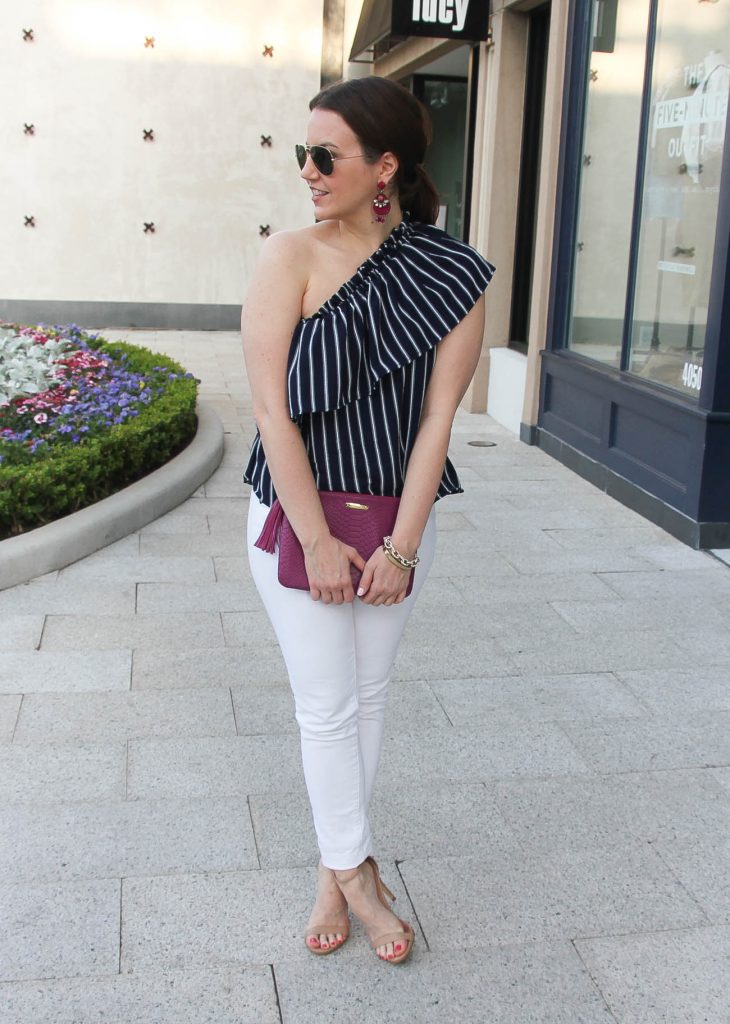 Houston style blogger wears a cute outfit idea for outdoor party with white jeans.