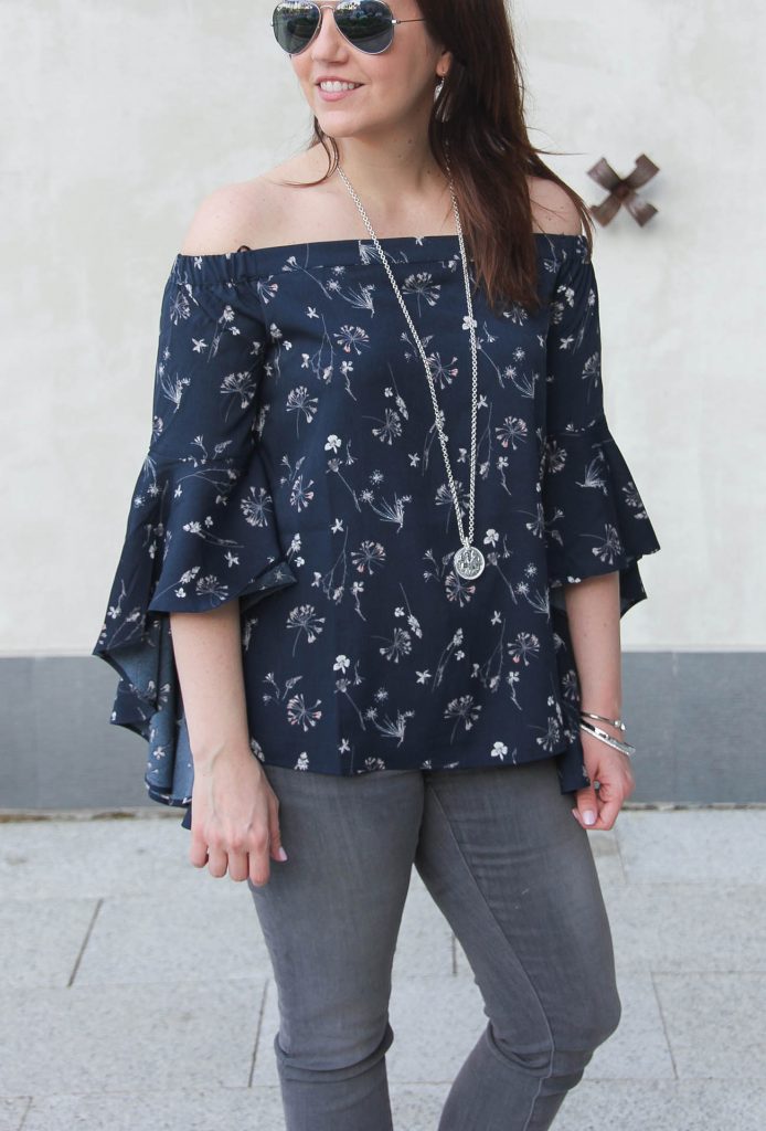 Houston based fashion blogger styles spring fashion trends including a bell sleeves off the shoulder top.