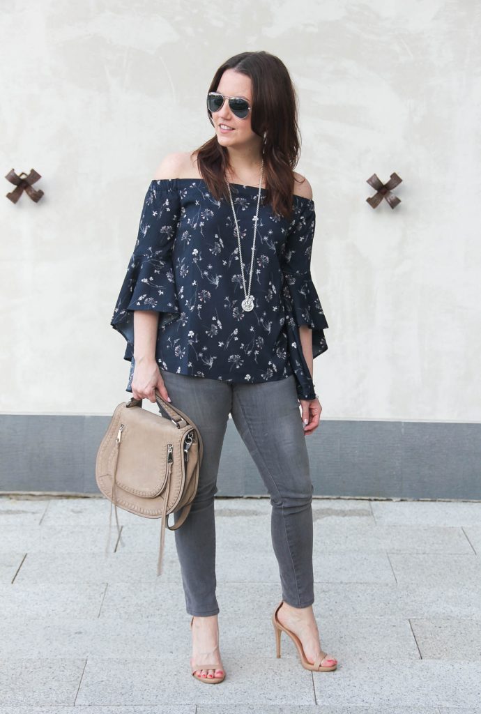 Houston fashion blogger wears spring trends including floral bell sleeve off the shoulder top with gray jeans and sandals.