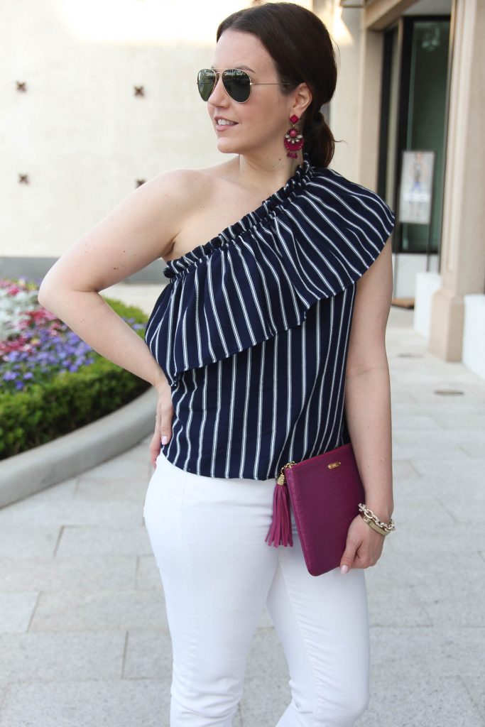 Houston fashion blogger wears chic spring outfit idea including a one shoulder top with white jeans.