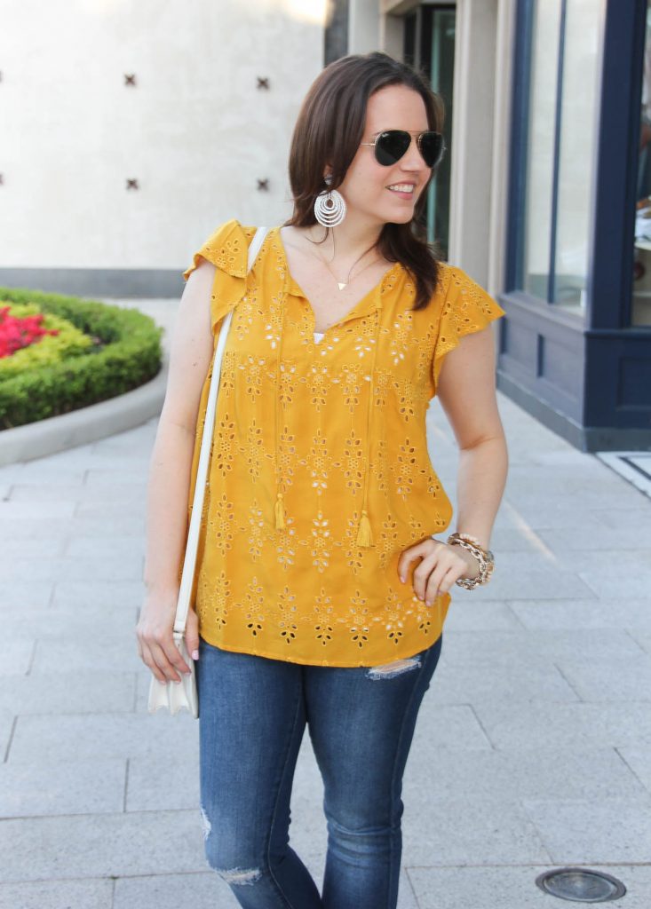 Houston style blogger Lady in Violet wears casual outfit ideas featuring yellow top and white earrings.