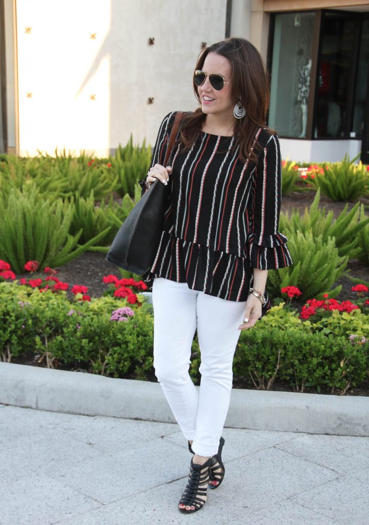 Houston fashion blogger wears weekend outfit idea including peplum top with white jeans and black wedges.