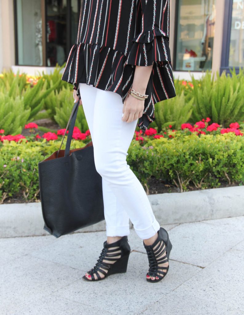 spring outfit inspiration including white skinny jeans, black caged wedges, and peplum top with bell sleeves.