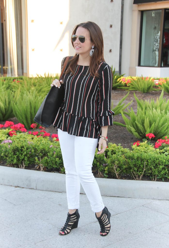 Houston fashion blogger wears weekend outfit idea including white jeans, black wedges, and peplum top.