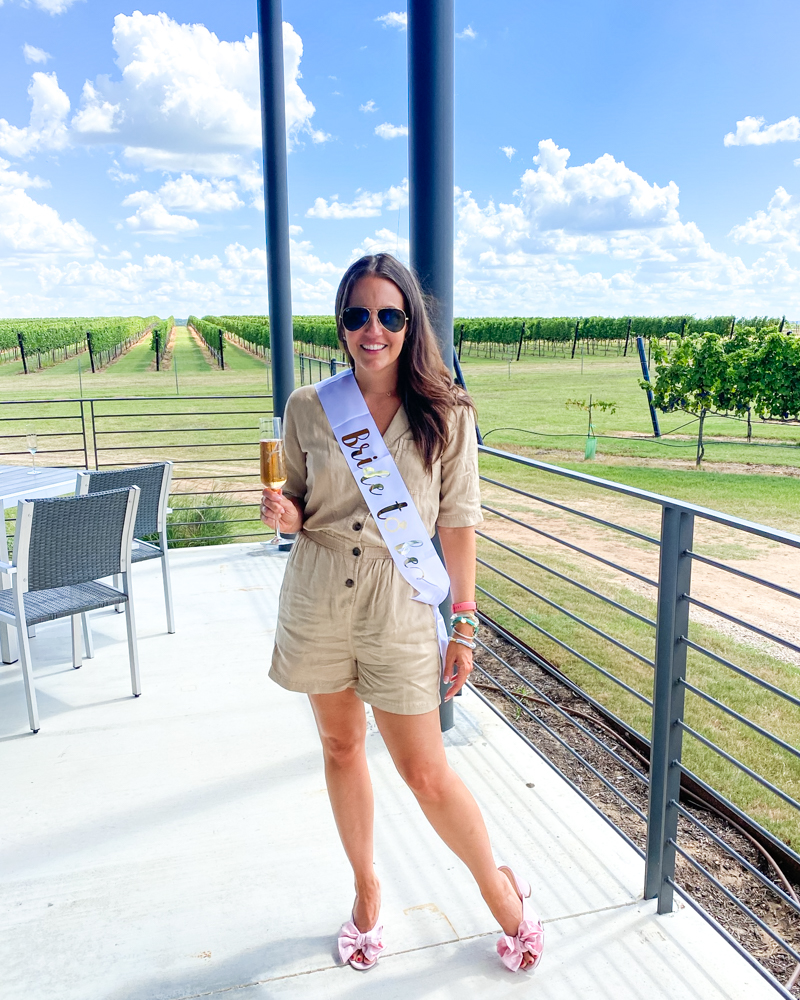 bachelorette weekend outfit | light tan romper | pink bow slides | Texas Fashion Blogger Lady in Violet