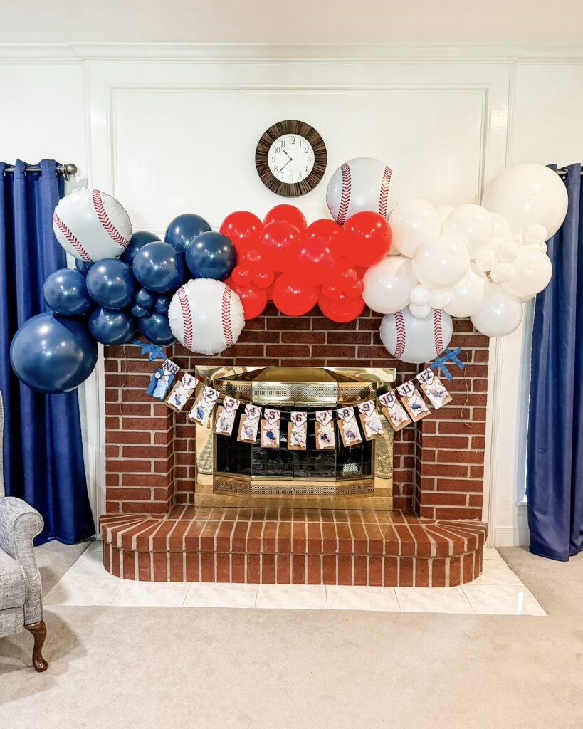 rookie of the year first birthday party | baby photo dislplay | balloon arch red white blue | Lifestyle Blog Lady in Violet